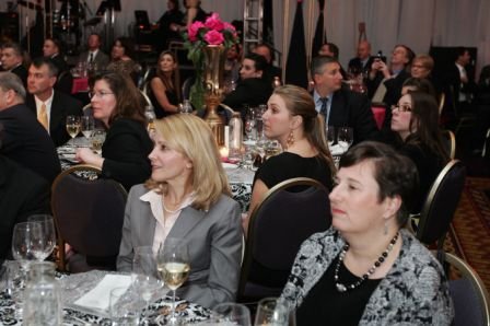 Attendees of the 2010 Charity Gala listen in about the $2 million raised for the Breast Cancer Foundation and the Haiti Relief Fund